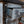 Load image into Gallery viewer, A vintage white metal end table with the top drawer extended.