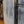 Load image into Gallery viewer, Close up side view of a refurbished white, metal end table.