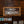 Load image into Gallery viewer, A brown "No Smoking" sign rests against a chest of drawers.