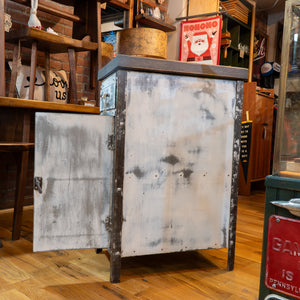 Side view of a white metal cabinet with the  front door open. 
