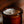Candle in a brown jar with a blurred background