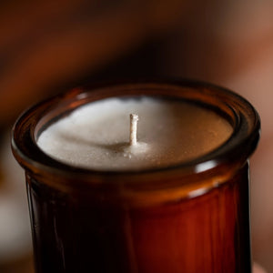 Candle in a brown jar with a blurred background