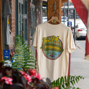A white t-shirt that says "Fort Pitt Trading Co's Pittsburgh Pickles" hanging outside on a door.